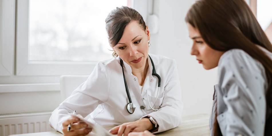 A woman and her doctor go over her test results.