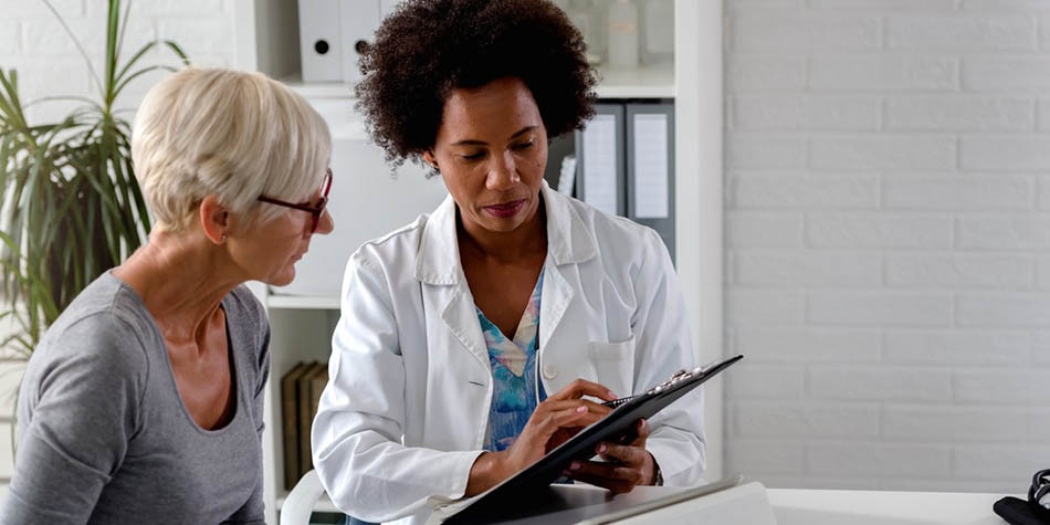 A doctor speaks to a patient.