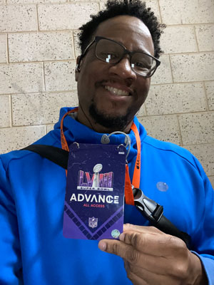 Chris Allen holding Super Bowl all access pass.